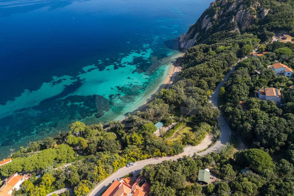 an aerial view of a beach and the ocean at Casette nel Parco in Portoferraio