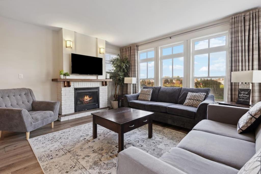 a living room with a couch and a fireplace at Alpine Breeze Getaway at Blue in Blue Mountains
