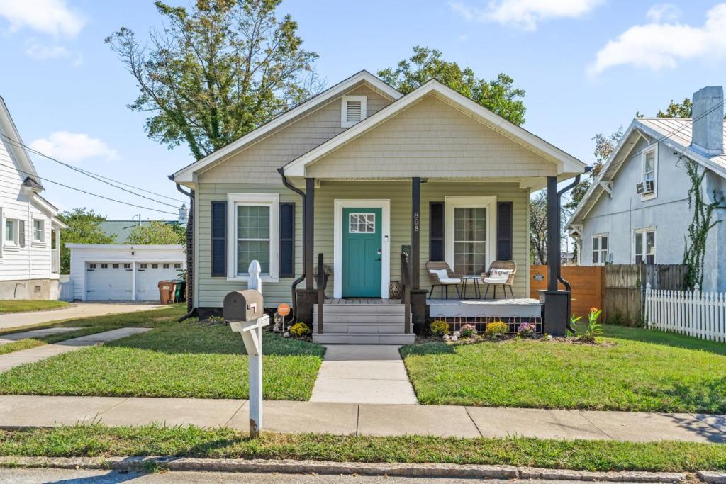 a house with a blue door and a parking meter at Hygge High Point by Rather Be Properties in High Point