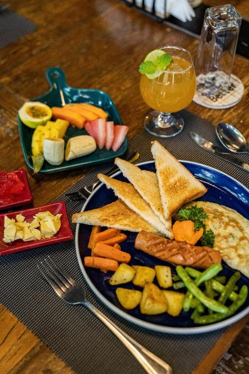 a blue plate of food on a wooden table at Ocean Light Mirissa in Mirissa
