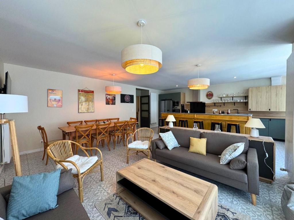 a living room with a couch and a table at l'Ancien Bistrot in Saint-Martin-de-Bréthencourt