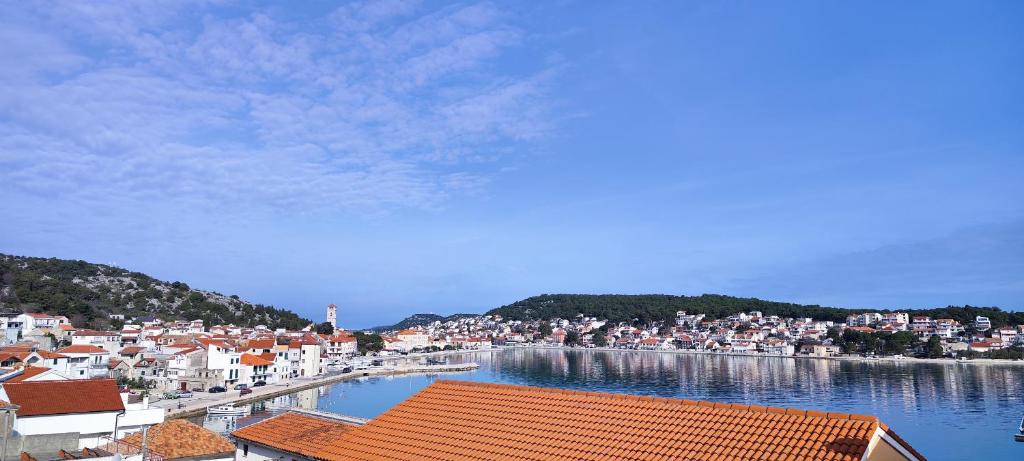 a view of a town with a body of water at Apartmany Tisno Perica in Tisno