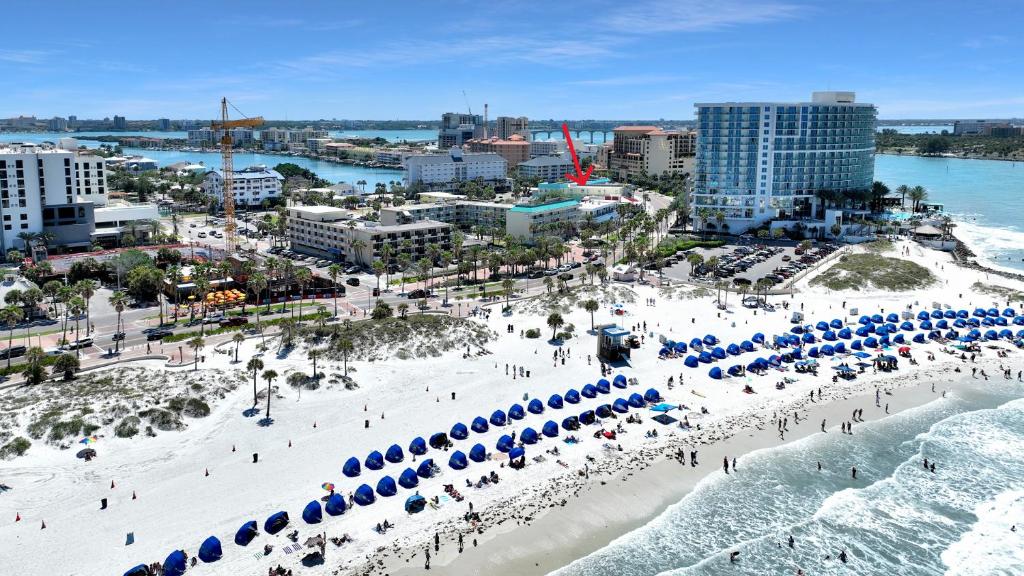 an aerial view of a beach with blue umbrellas at Pelican Pointe Clearwater Beach Hotel in Clearwater Beach