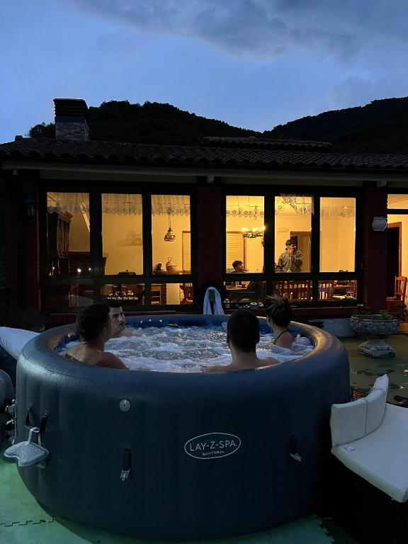 a group of people sitting in a hot tub at Casa Luisín Jacuzzi exterior Casa completa 10 personas in El Pino