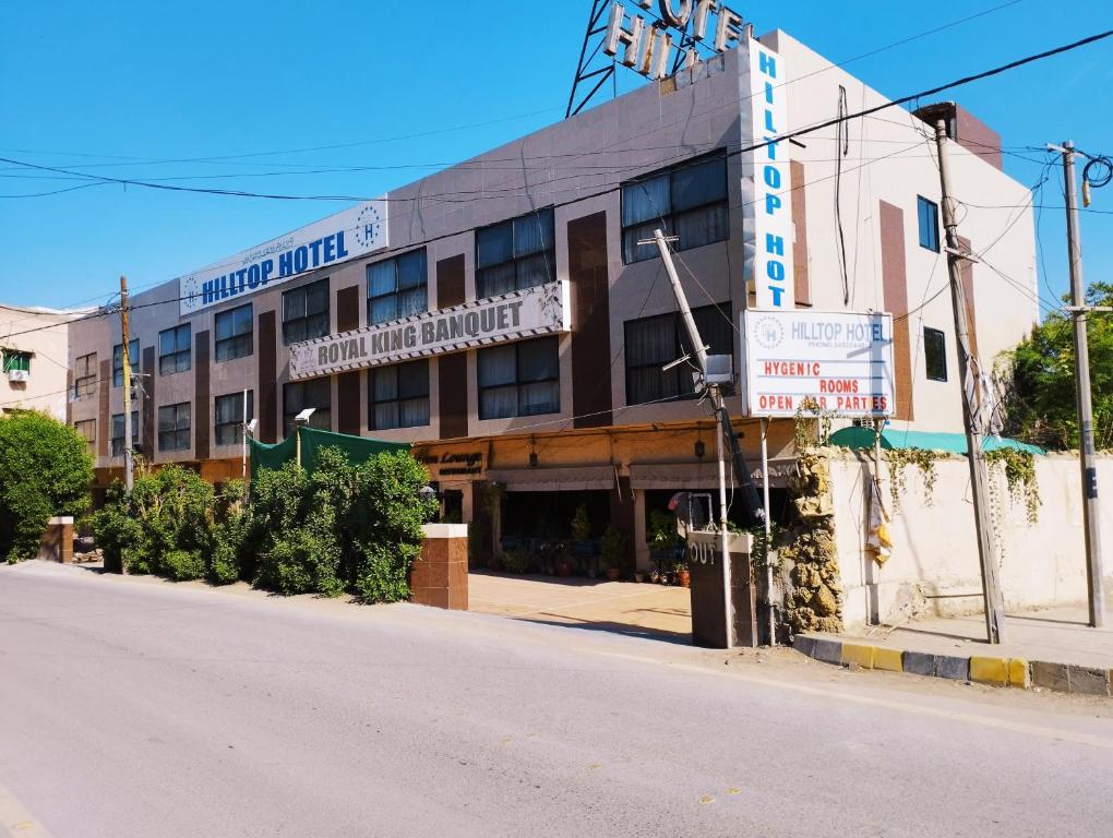 an empty street in front of a building at HillTop Hotel in Karachi