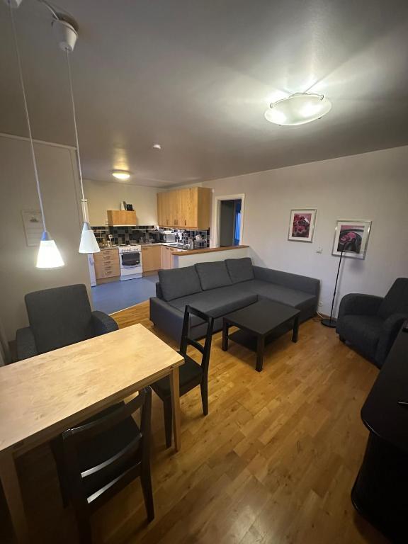 a living room with a couch and a table at Central accommodation in Umeå