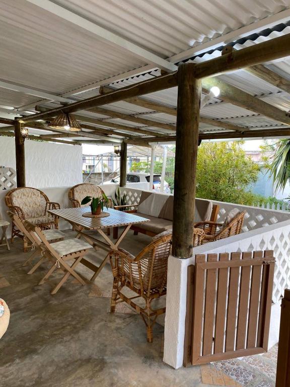 a patio with a table and chairs under a pergola at Kaz Kreol in Trou d'Eau Douce