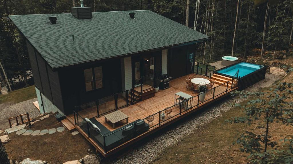 an overhead view of a house with a deck and a swimming pool at Zen House 5 - Villas & Spa in Lac-Superieur