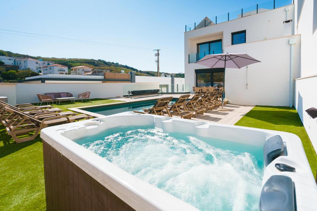 a hot tub on the roof of a house at Antica Villa, luxury villa near the beach in Ribamar