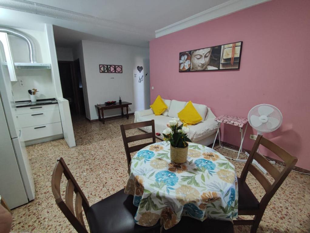 a living room with a table and a couch at LUCERO APARTAMENTO in Madrid