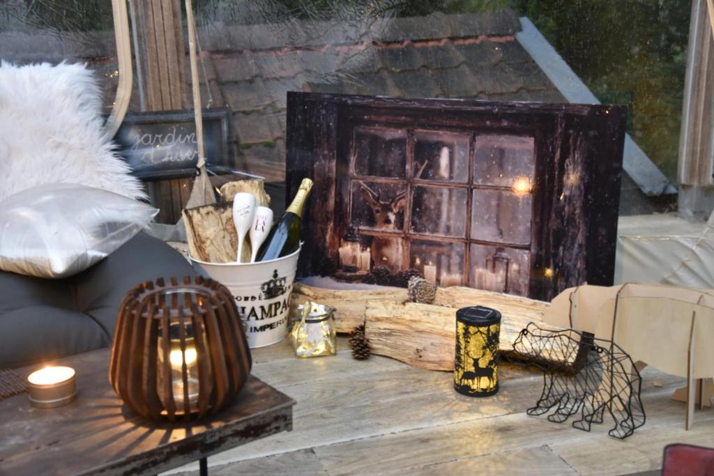 a wooden table with a fireplace in a room at Studio autonome magnifique avec JARDIN d hiver TB situé Chaumont-Gistoux in Chaumont-Gistoux