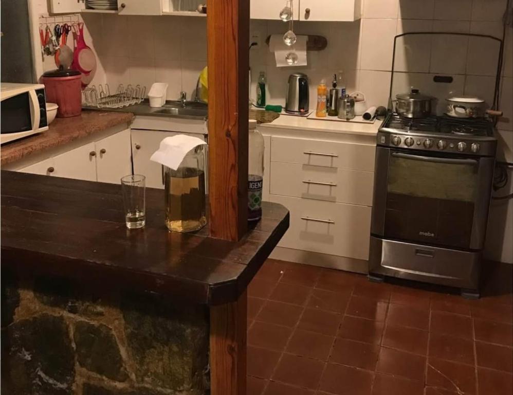 a kitchen with a stove and a counter top at Hospedaje Jazminne in El Cerrillo