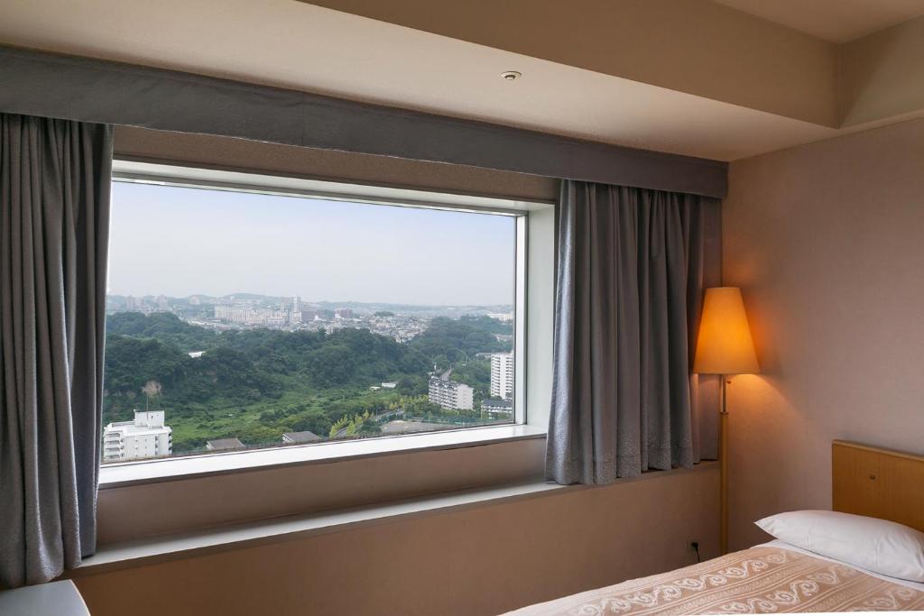 Postel nebo postele na pokoji v ubytování Yokohama Techno Tower Hotel