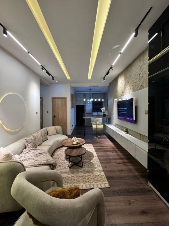 a living room with a couch and a tv at AmandaHome in Lekki
