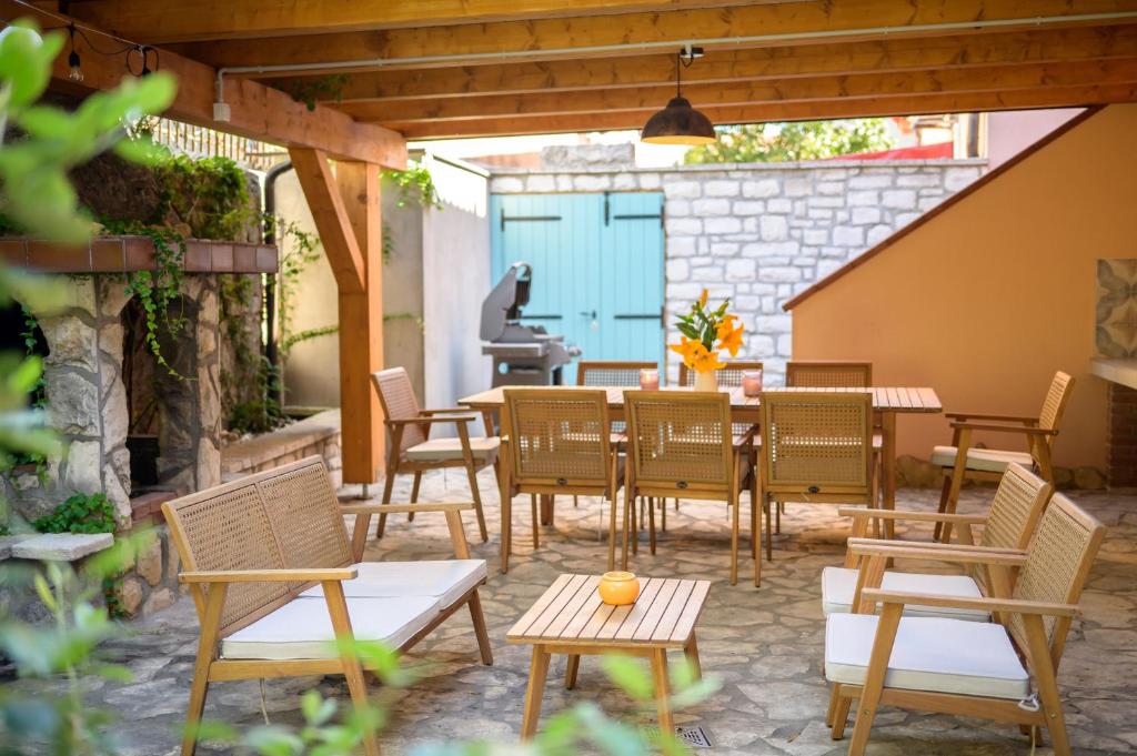 a patio with chairs and a table and a table and chairs at Atelier LAKOTA in Brtonigla