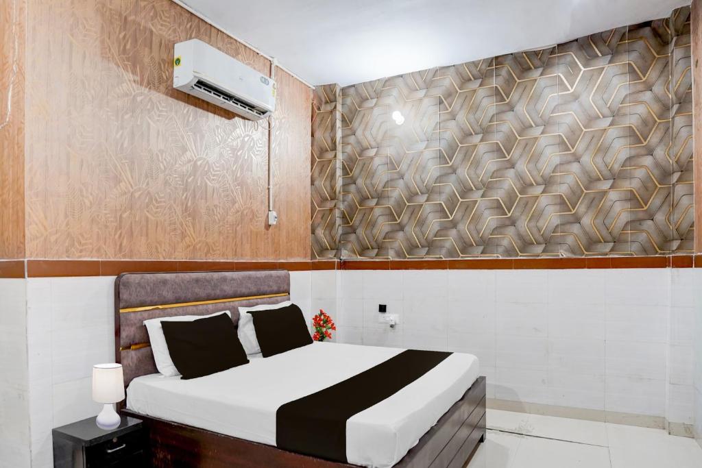 a bedroom with a bed and a air conditioner at Hotel O Brij Ghat Mukteshwar Formerly Brijwasi Guest House in Kankather