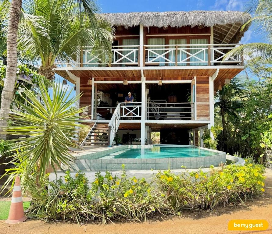 a house with a pool in front of it at Vila Pukara - Moitas in Praia de Moitas