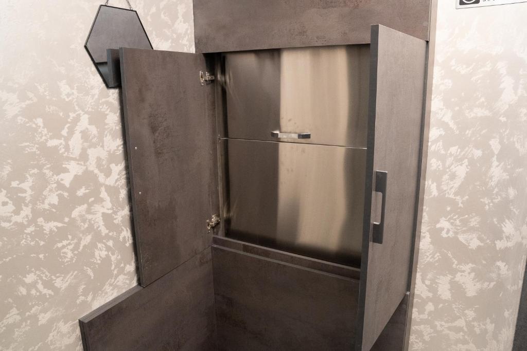 a metal door in a room with a wall at Prime Suites Hotel in Yerevan