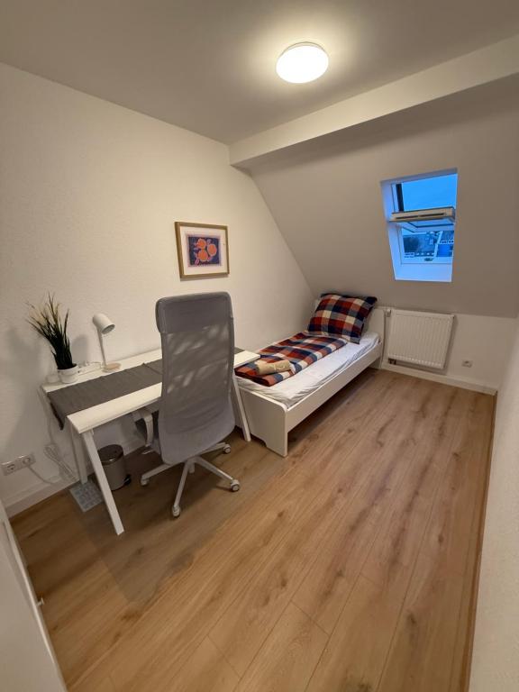 a bedroom with a desk and a bed and a desk and a chair at Zimmer direkt an dem Rheinsteig neben der WHU mitten im Zentrum von Vallendar in Vallendar