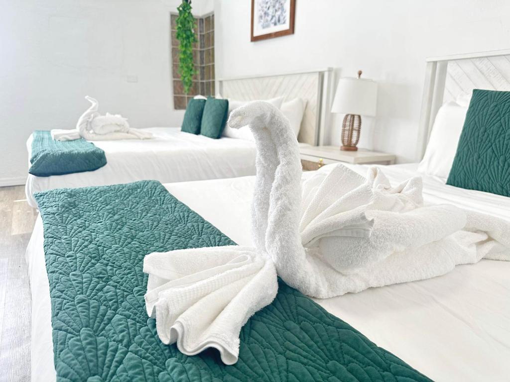 a swan towel sitting on top of two beds at Speciose Unit With Kitchen And Community Pool in Clearwater