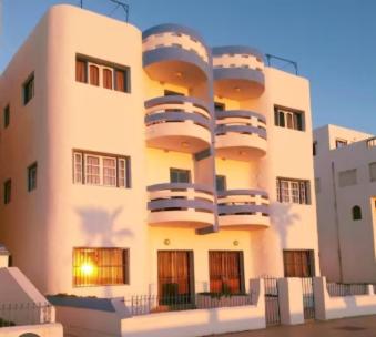 a building with balconies on the side of it at Restinga in Oulad Akkou