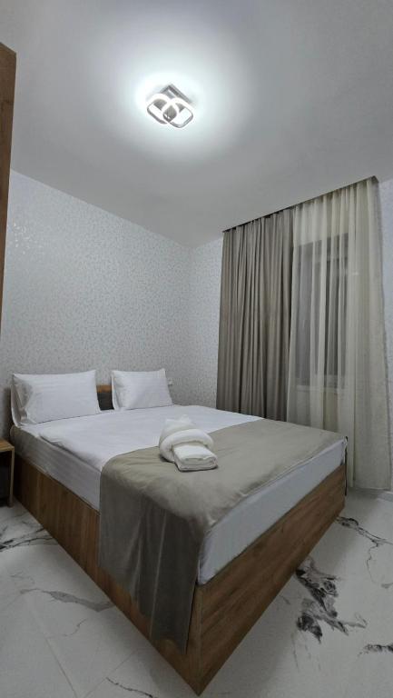 a bedroom with a large bed with at Airport Inn in Pʼarakʼar