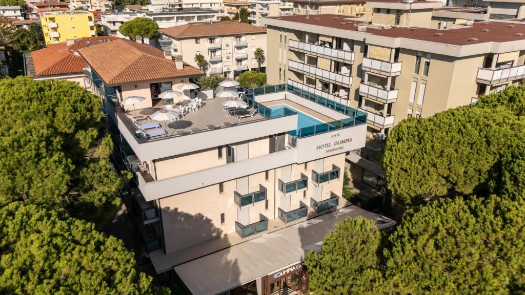 an aerial view of a building with a swimming pool at Olimpia Hotel & Aparthotel in Bibione