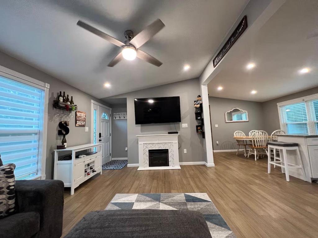 a living room with a fireplace and a flat screen tv at Beautiful 3 BR Near Town & Beach w King Bed in Patchogue