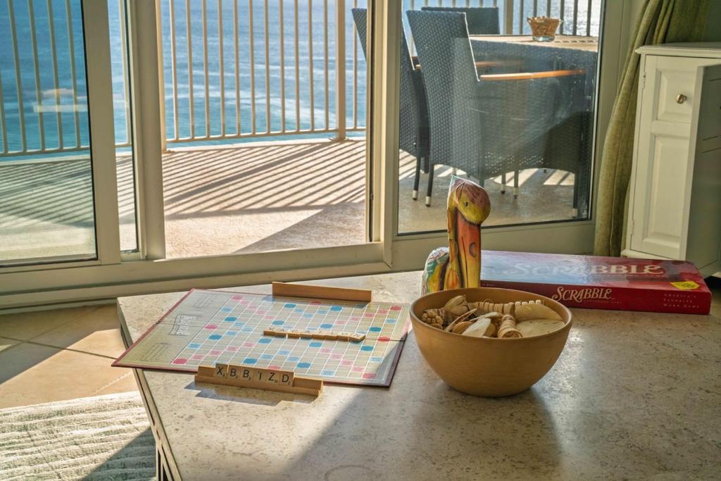 a table with a map and a bowl of mushrooms at Luxury 2BR Beachfront Condo - Panama City Beach in Panama City Beach