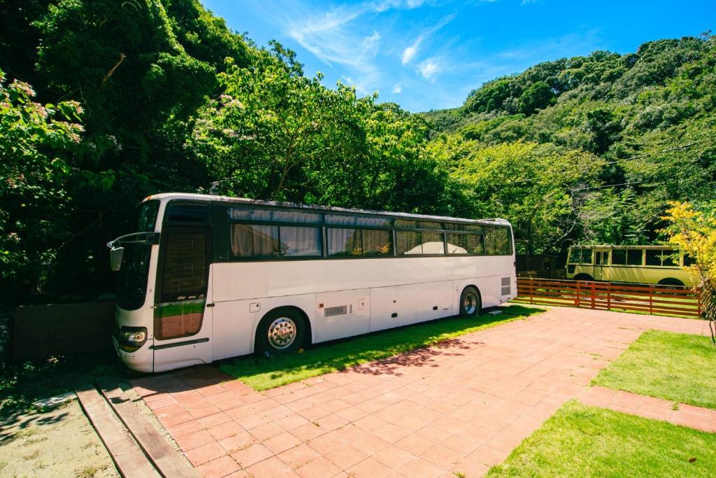 a white bus parked in a parking lot at Yura Green - Vacation STAY 65841v in Yura