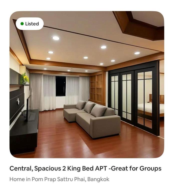 a living room with a couch and a bed at Omalaya Bangkok in Samphanthawong