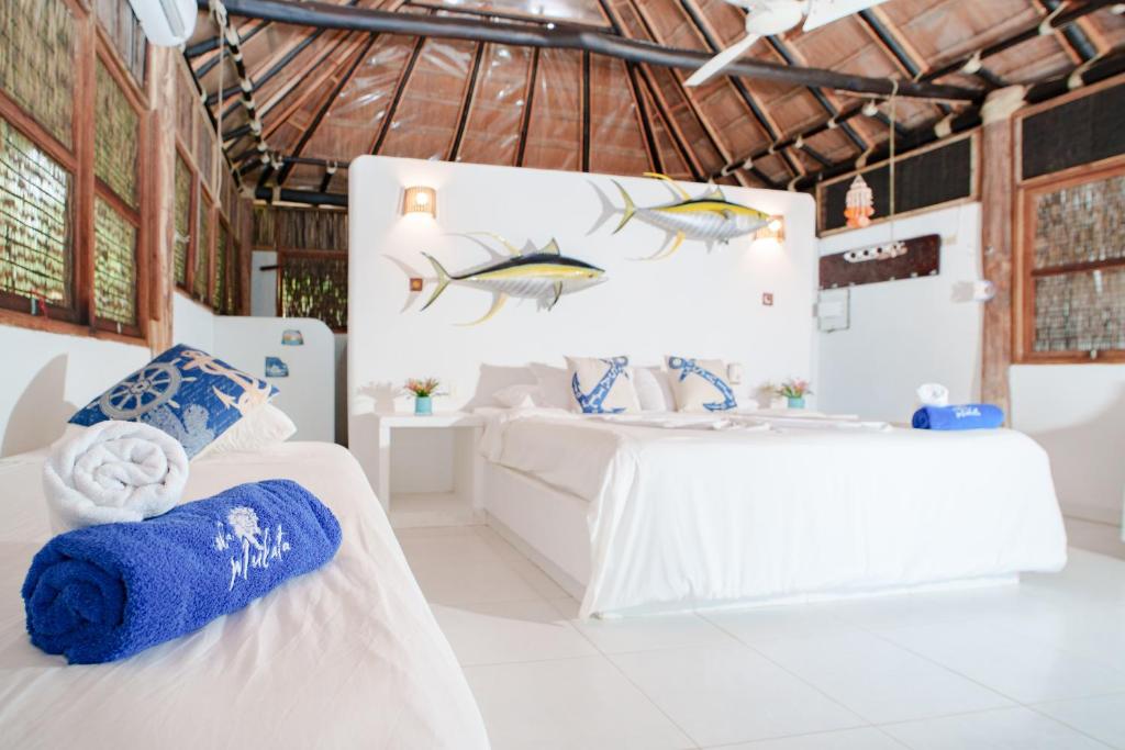 Katil atau katil-katil dalam bilik di Isla Mulata, Islas del Rosario