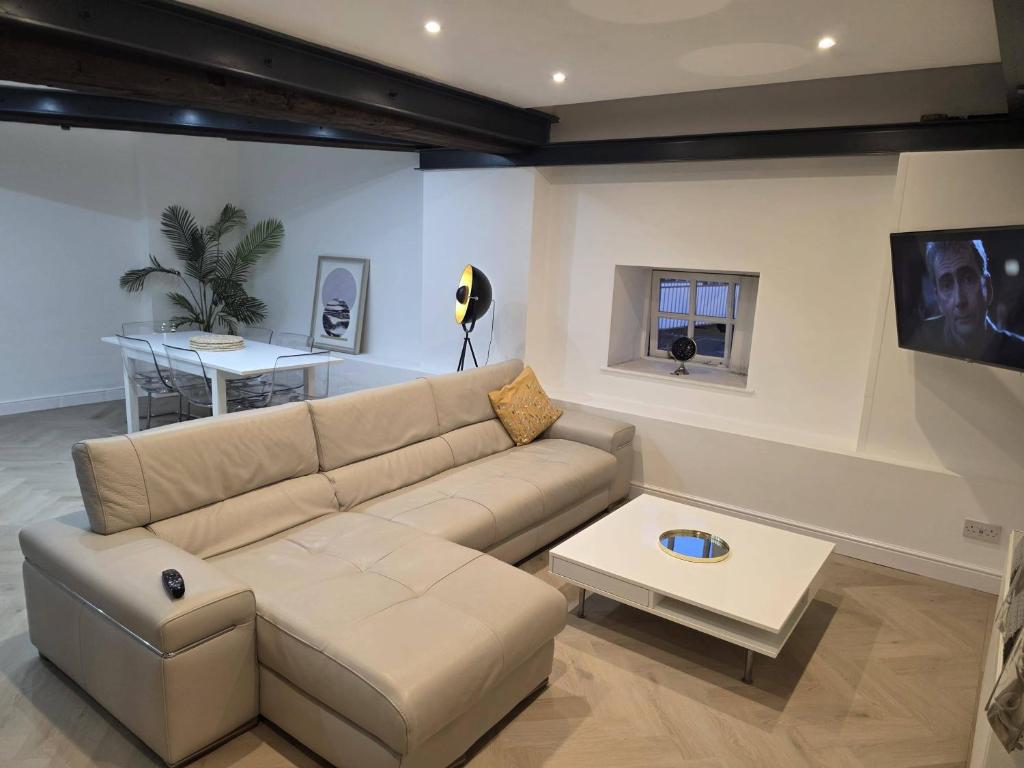 a living room with a couch and a table at Liverpool Penthouse - Sleeps 8 - City Centre in Liverpool