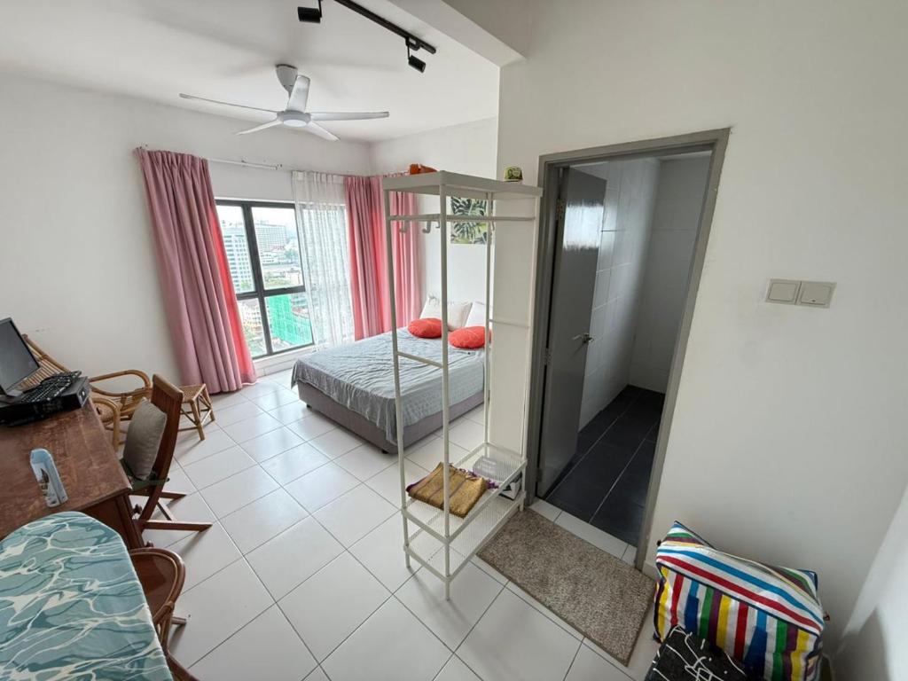 a living room with a bed and a mirror at Metia residence in Shah Alam
