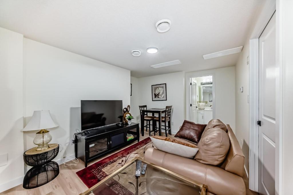 a living room with a couch and a television at KimzNest in Edmonton