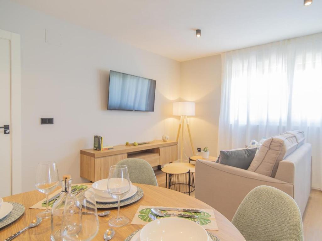 a living room with a table and chairs and a couch at Apartamento Mar Salada La Maruca in Santander