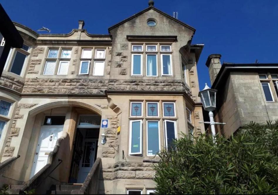 a large stone house with a large window at En-suite Double Room in Bath