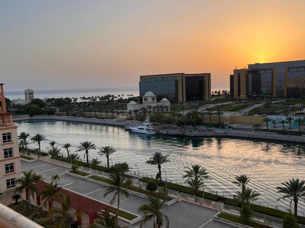a view of a river with palm trees and buildings at تالية مارينا هاوس غرفتين TALIA MARINA FAMILIES PROFESSIONALs in King Abdullah Economic City