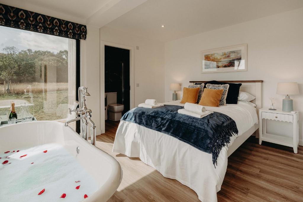 a bedroom with a large bed and a bath tub at The Granary Estates 