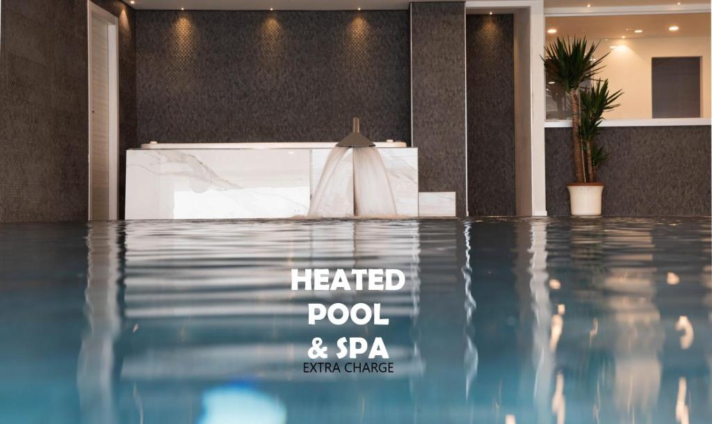 a hotel lobby with a heated pool and spa at GARNI' FOCI in Riva del Garda