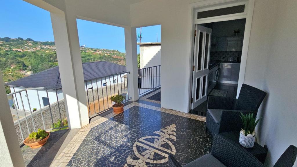 a balcony with chairs and a view of the ocean at Lower Floor In Flor do Campo - Santana in Santana
