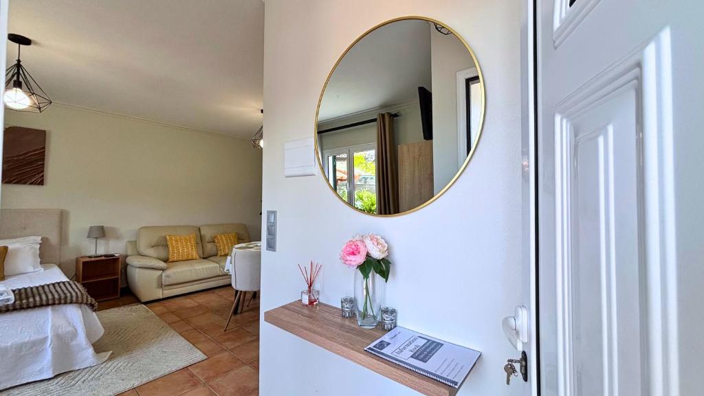 1 dormitorio con espejo y sala de estar en Island Loft, en Ribeira Brava