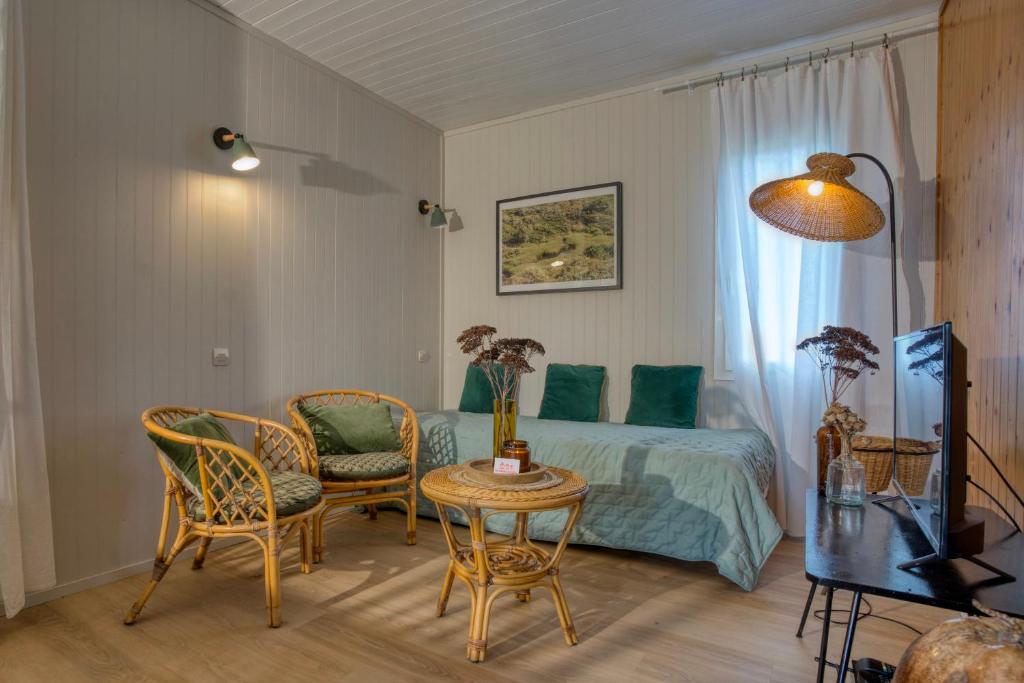 una camera da letto con un letto, un tavolo e delle sedie di Chalet en plein nature, gorges de la Dordogne a Sérandon