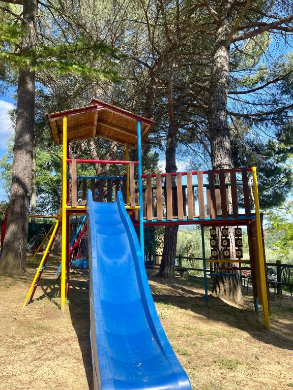a playground with a blue slide in a park at Agriturismo Vernianello in Poggibonsi