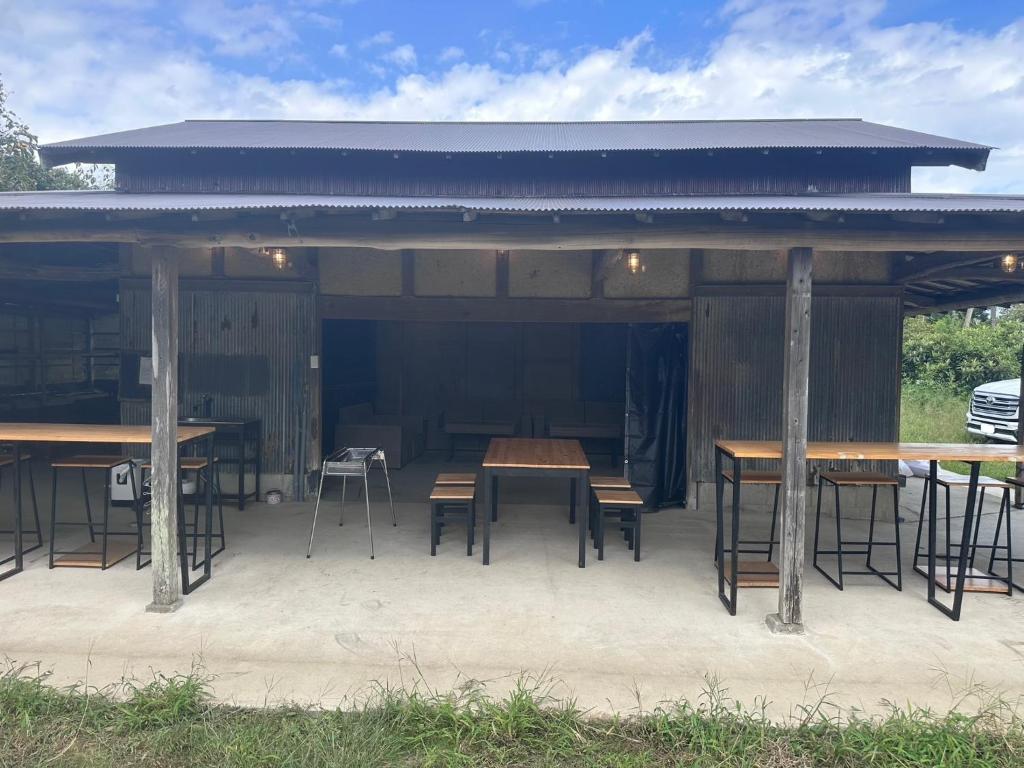 a wooden pavilion with tables and chairs in it at KominkaGlamping NAYA - Vacation STAY 20482 in Chosei