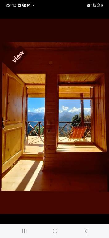 two windows in a room with a view of the ocean at Heshklar guest house in Keshkili