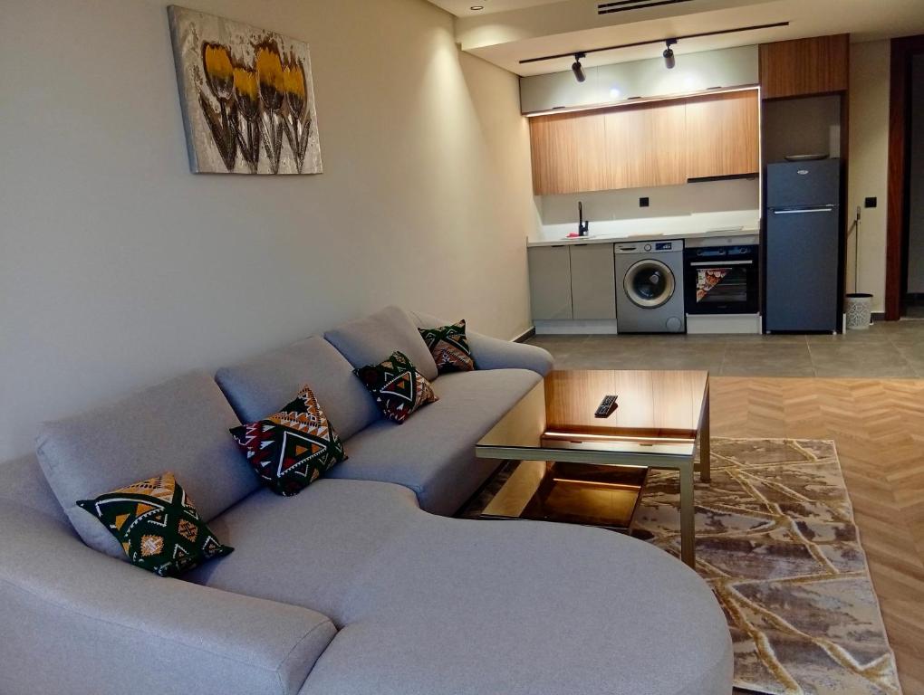 a living room with a couch and a table at Casablanca Luxury Studio - Family & Solo Friendly in Casablanca