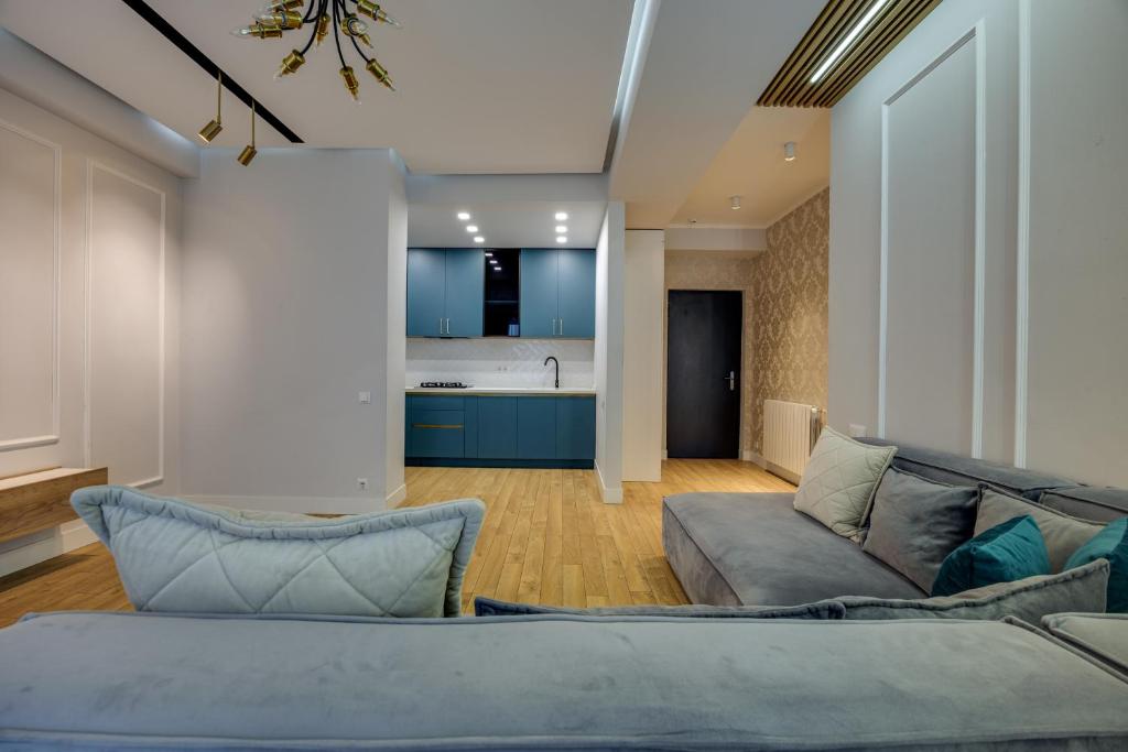 a living room with a couch and a kitchen at Hilton ApartHotel in Tbilisi City