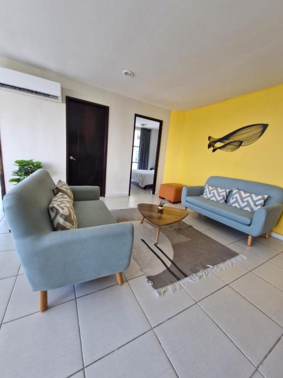 a living room with two couches and a table at Sea View 10 Boca Towers in Boca del Río