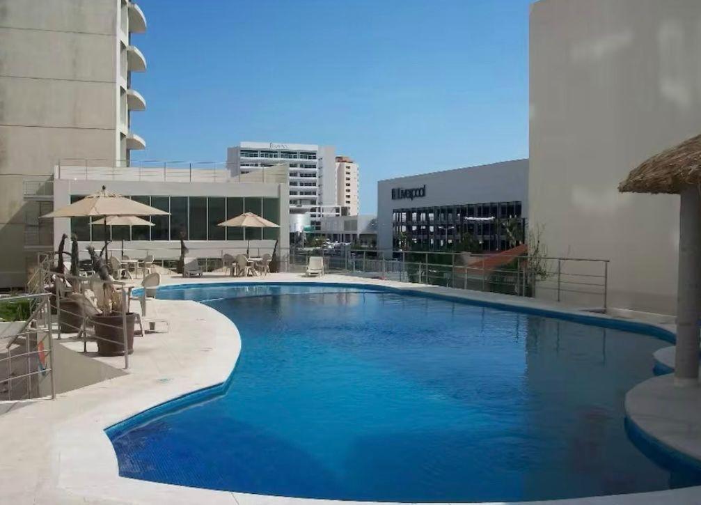 a large blue swimming pool in front of a building at Sea View 10 Boca Towers in Boca del Río